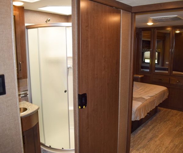 A bathroom with a shower and toilet in it