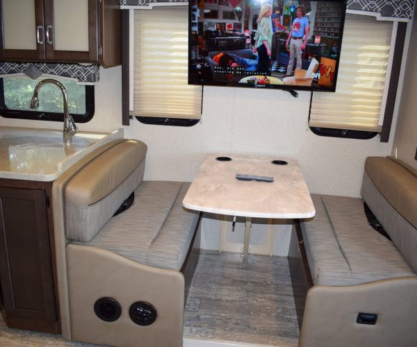 A tv mounted on the wall in a motorhome.