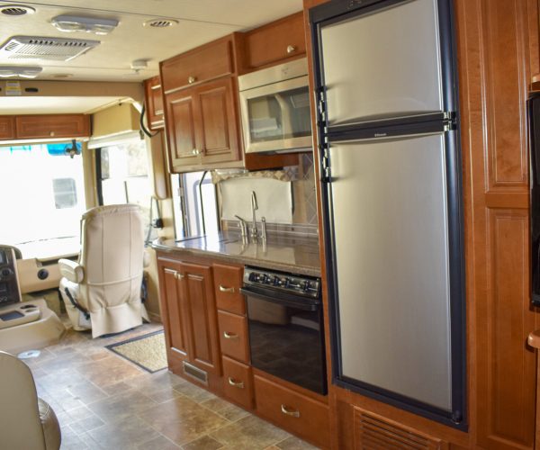 A kitchen with wood cabinets and stainless steel appliances.