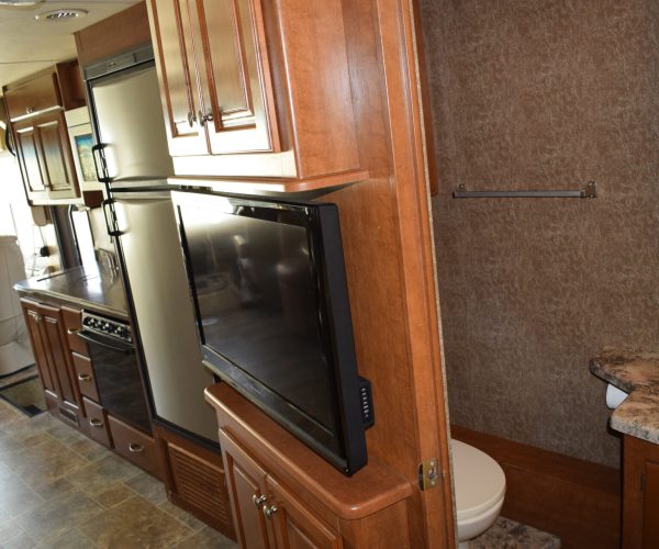 A kitchen with wood cabinets and stainless steel appliances.