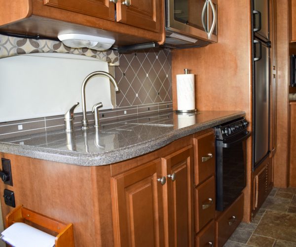 A kitchen with wooden cabinets and stainless steel appliances.