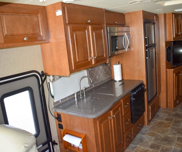 A kitchen with wood cabinets and stainless steel appliances.