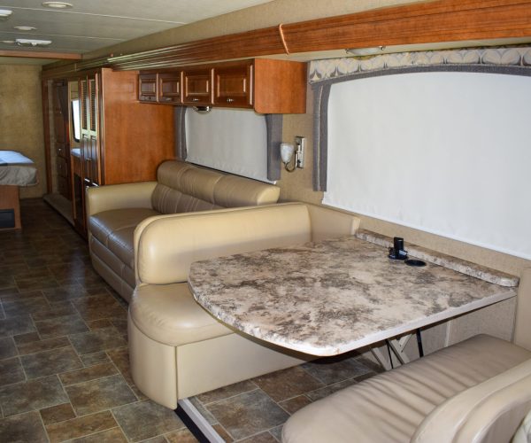 A living room with a couch, table and chairs.