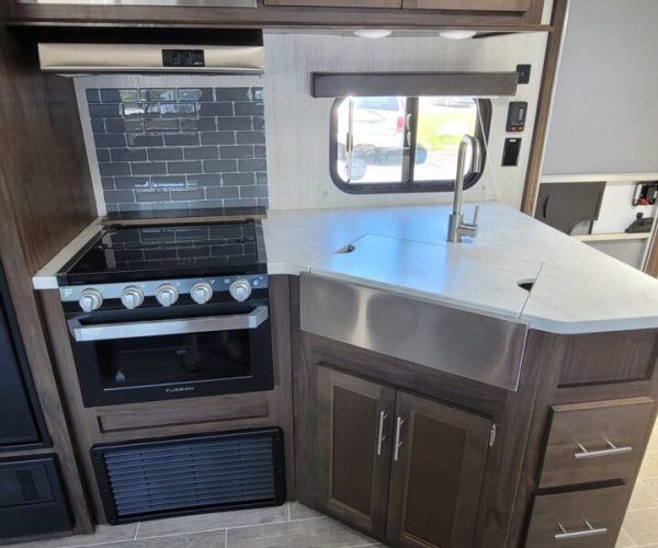 A kitchen with an oven and microwave in it