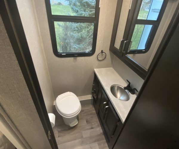 A bathroom with a toilet and sink in it