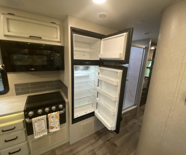 A refrigerator and stove in the kitchen of an rv.