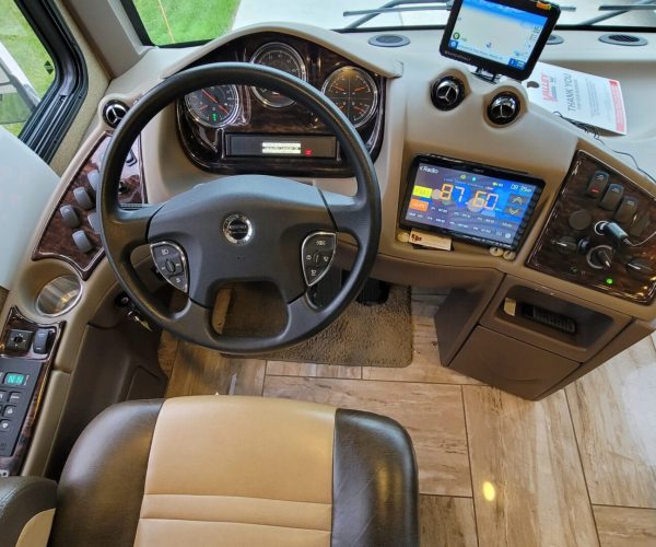 A view of the dashboard and steering wheel in an rv.