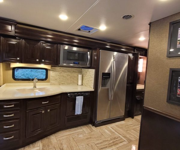 A kitchen with brown cabinets and stainless steel appliances.