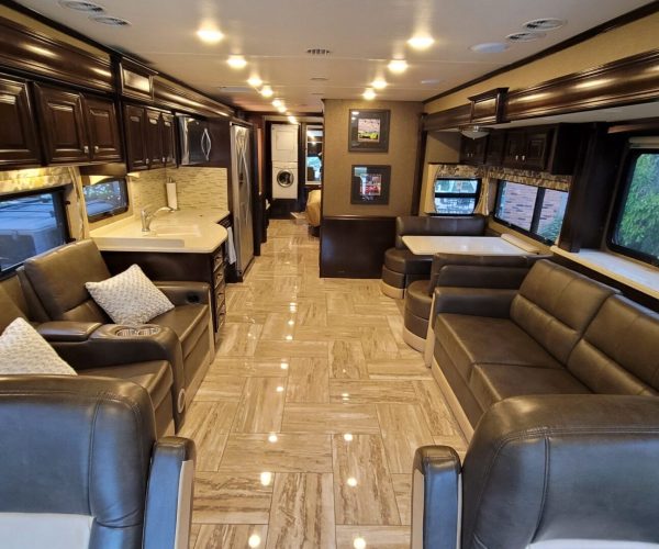 A large living room with leather furniture and marble floors.