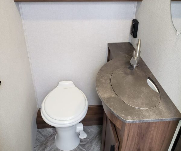 A bathroom with a toilet and sink in it