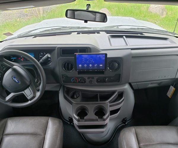 A dashboard of an rv with the center console turned on.