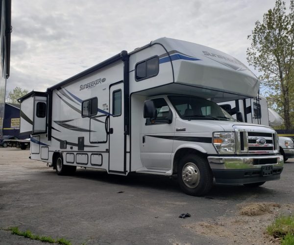 A white rv parked in the parking lot.