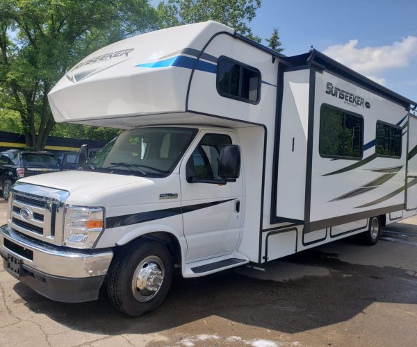 A white rv parked in the parking lot.